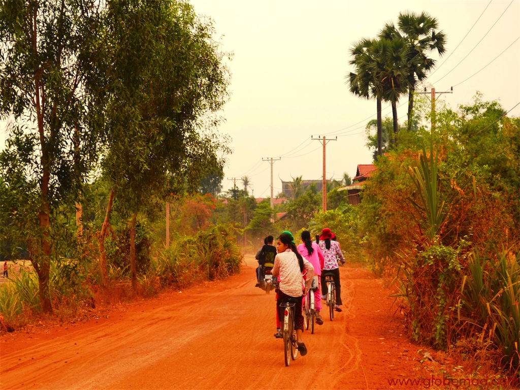 Travel inspiration photos for backpacking in Cambbodia Globemad blogger photographs dusty red roads in villages